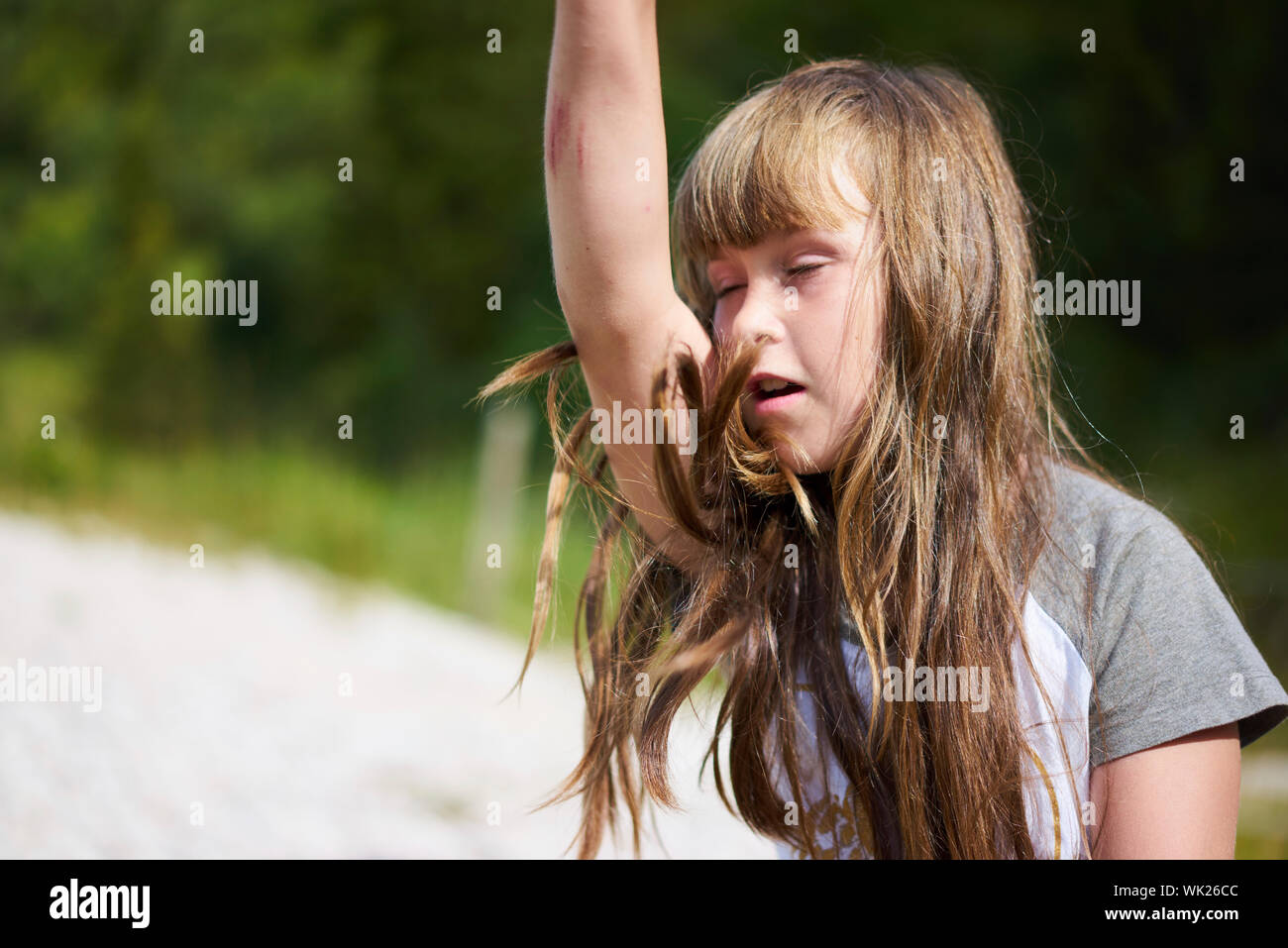Close-up Of Tired Girl With Arms Raised Stock Photo