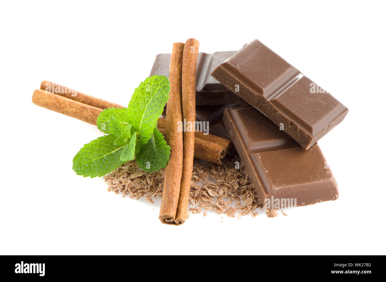 Chocolate parts and cinnamon sticks isolated on white background Stock