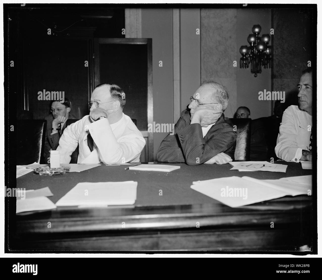 Interested listeners. Washington, D.C., July 19. Senators Francis T. Maloney, Left, Connecticut, and George L. Radcliffe, Maryland, lend an attentive ear to the testimony of Marriner Eccles, Chairman of the Federal Reserve Board, before the Senate Banking and Currency Committee today. Eccles told the committee the president's lending program is the only immediately practicable means of stimulating business and employment up to prosperity, 7/19/39 Stock Photo