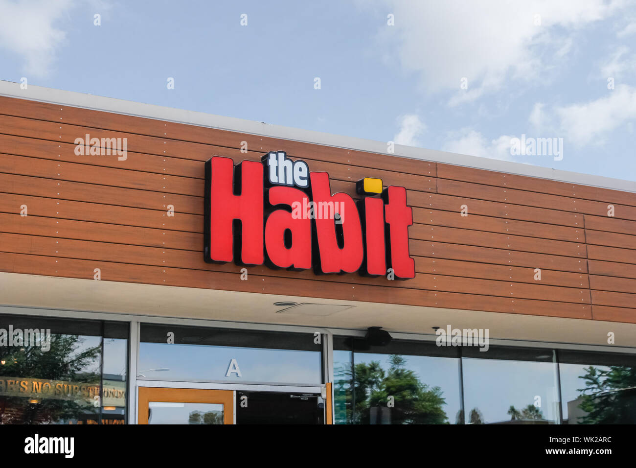 A store front sign for the gourmet burger chain known as The Habit Stock Photo