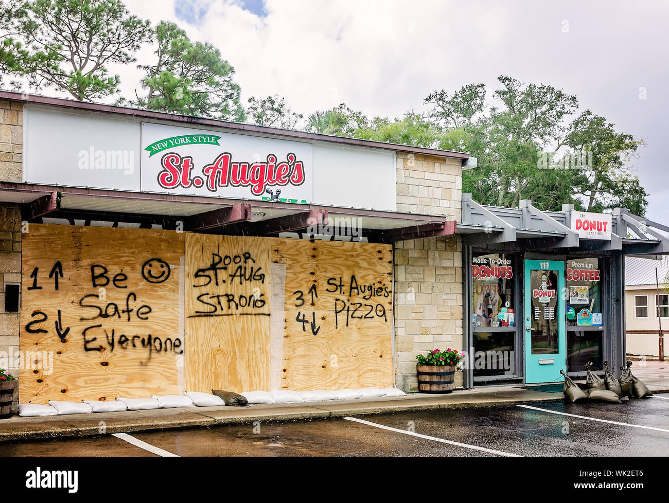 St. Augie’s Pizza is boarded up with plywood bearing the messages, “Be safe everyone” and “St. Aug Strong,” Sept. 2, 2019, in St. Augustine, Florida. Stock Photo