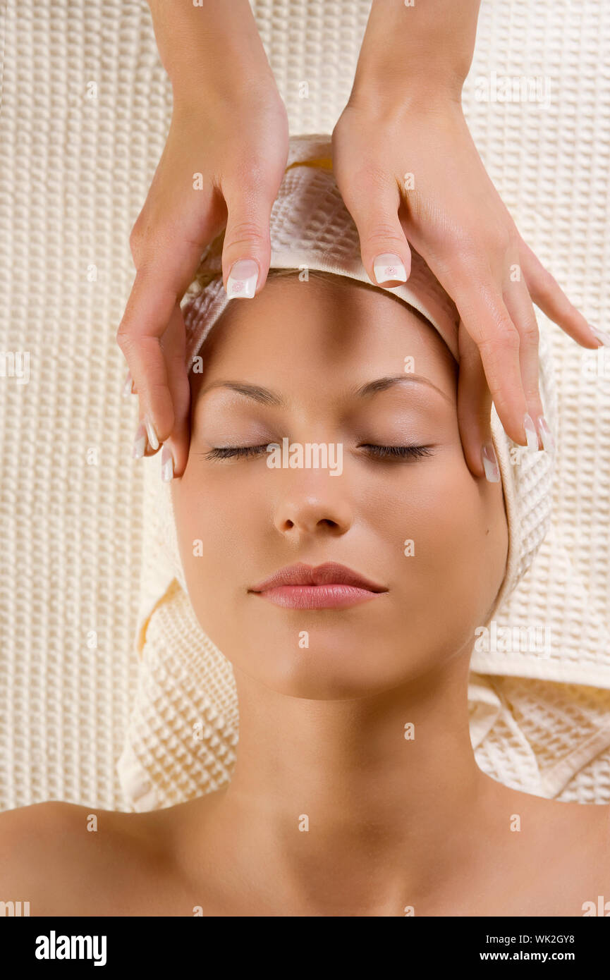 cute woman in a spa getting an hands massage for the headache Stock Photo Alamy
