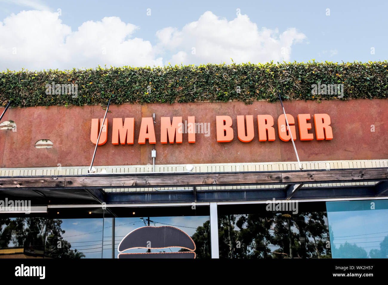A store front sign for the gourmet burger chain known as Umami Burger, located at The Camp Stock Photo