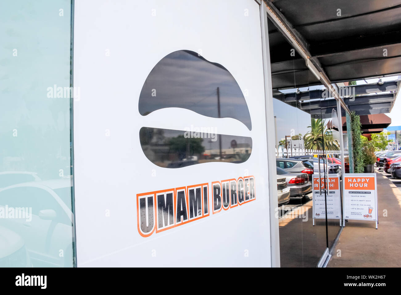 A store front sign for the gourmet burger chain known as Umami Burger, located at The Camp Stock Photo