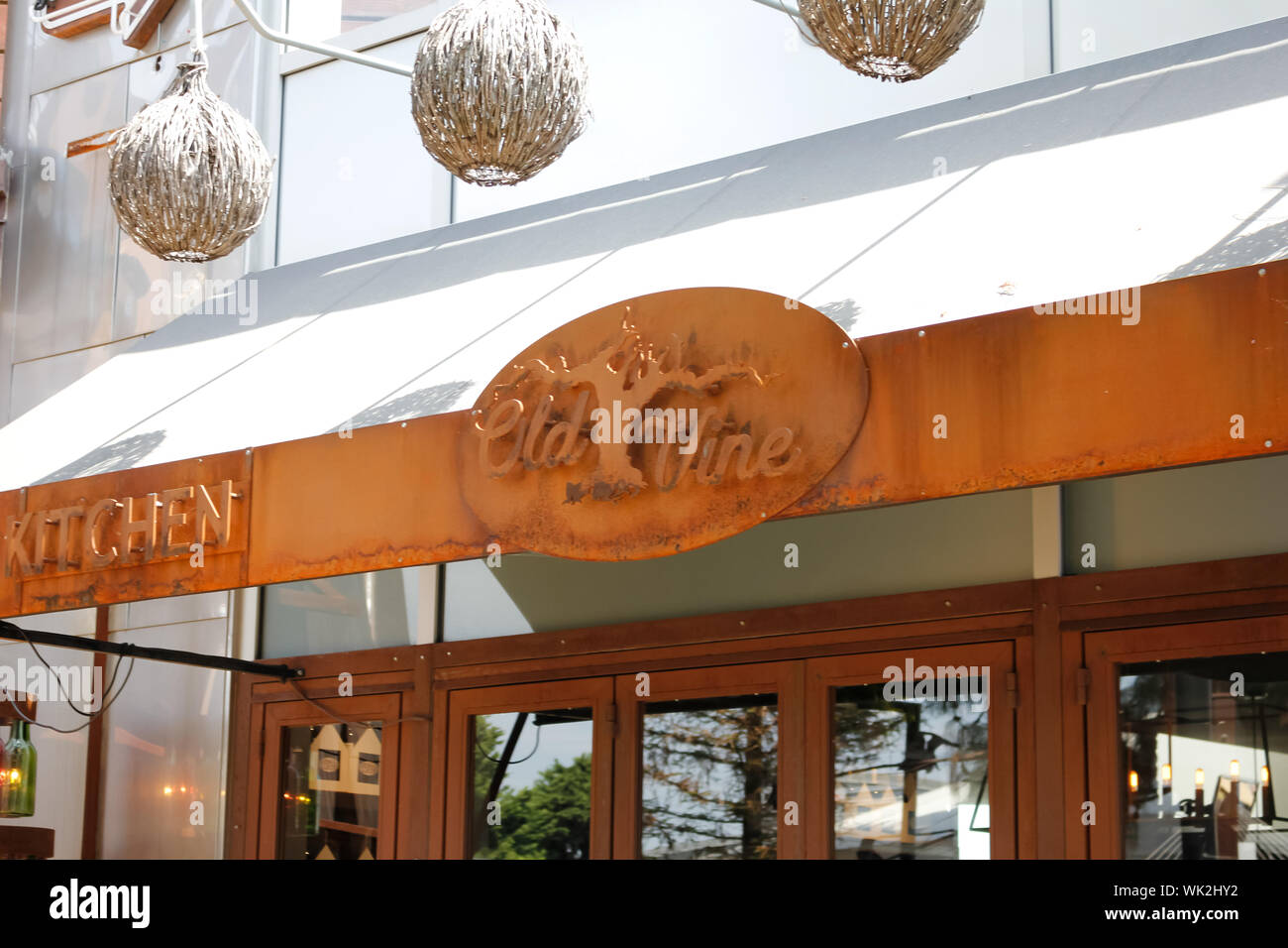 A store front sign for the restaurant known as Old Vine Kitchen & Bar