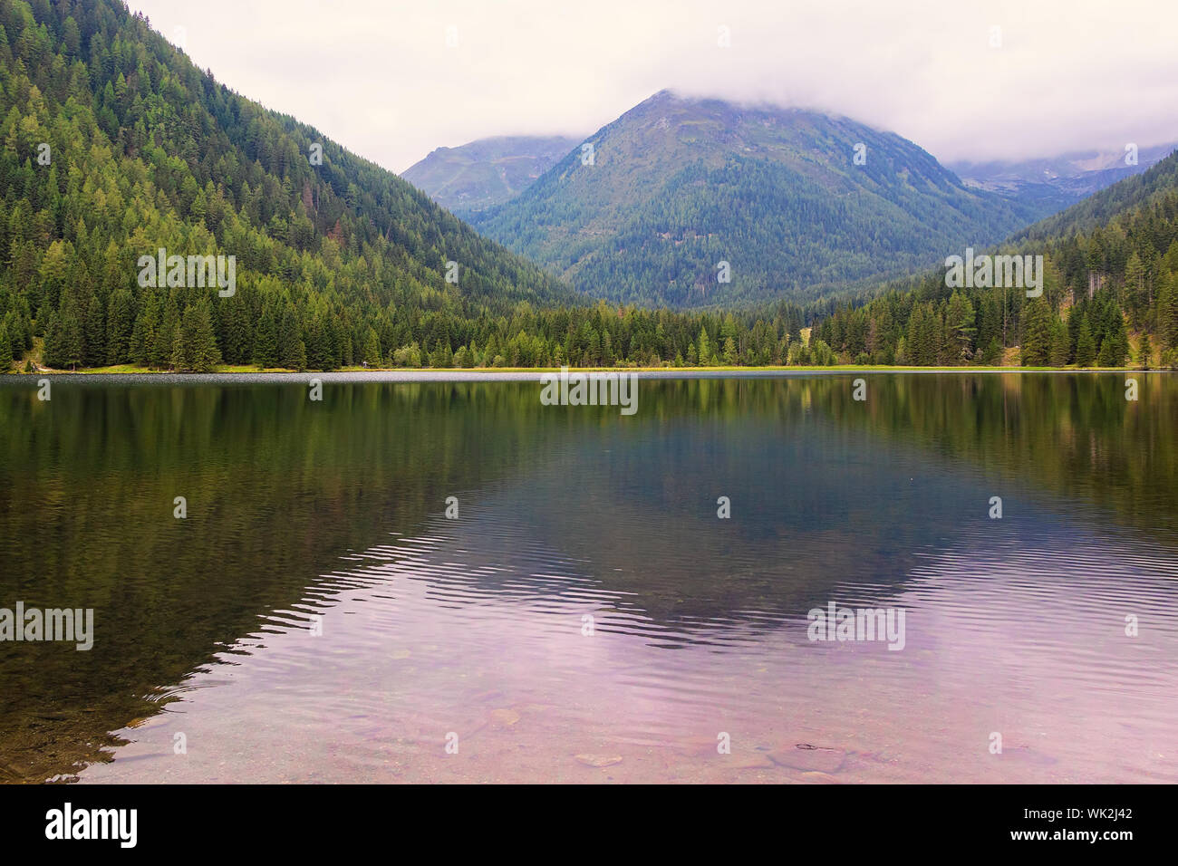 Austria Alps landscape panorama with mountain lake in morning fog with beautiful reflection, Etrachsee in Niedere Tauern near Schladming Dachstein Stock Photo