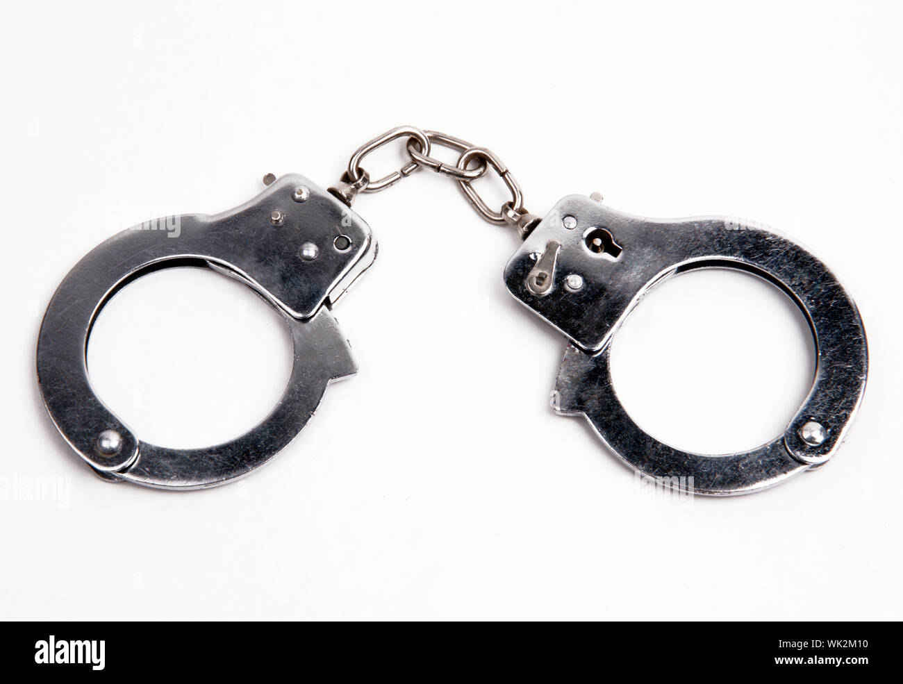 Metal handcuffs on white Stock Photo Alamy