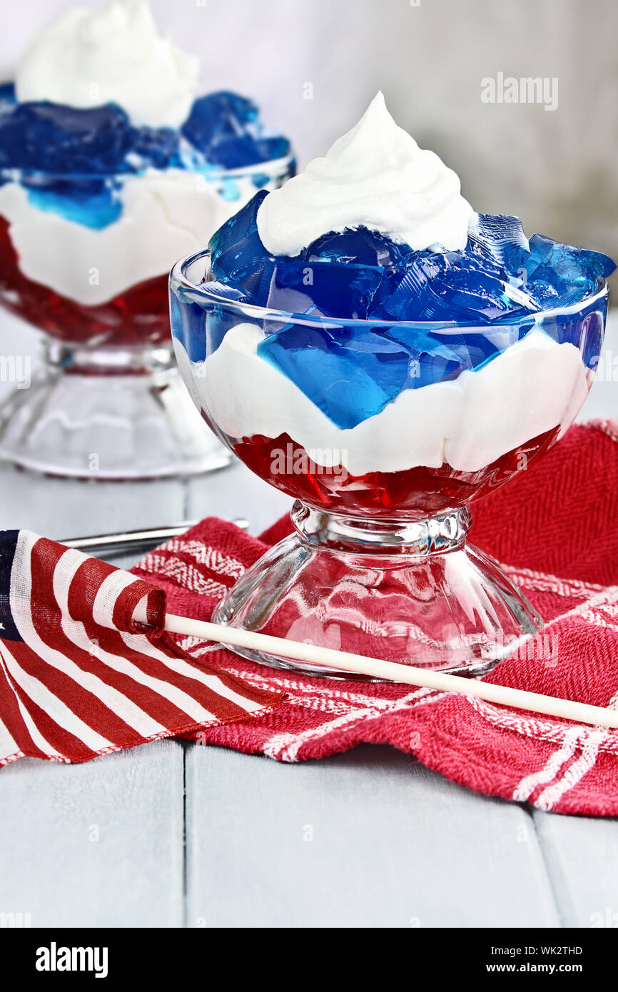 Gelatin layered dessert of cubes of red and blue jello with white flufy
