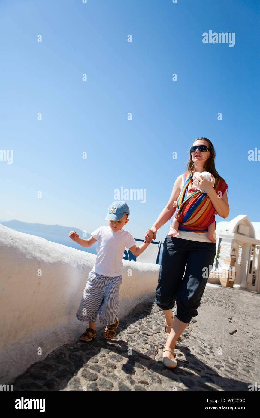 family-trip-to-europe-young-mother-with-two-kids-exploring-greek-town