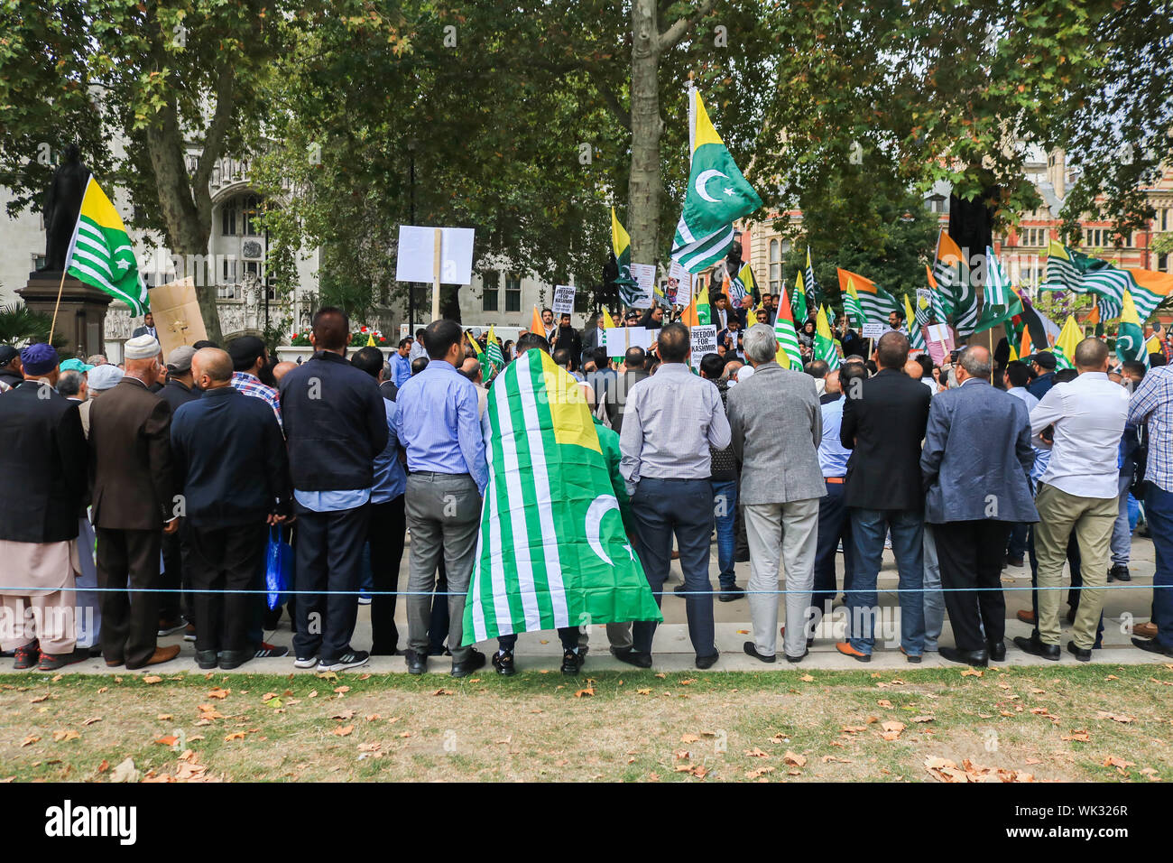 London, UK. 03rd Sep, 2019. A Protester wearing a Kashmiri flags stands with other protesters as they gather in Parliament Square around the statue of Gandhi in solidarity with the people of Kashmir after Indian Prime Minister Narendra Modi delivered an Independence Day speech to remove the special rights of Kashmir as an autonomous region. Credit: SOPA Images Limited/Alamy Live News Stock Photo