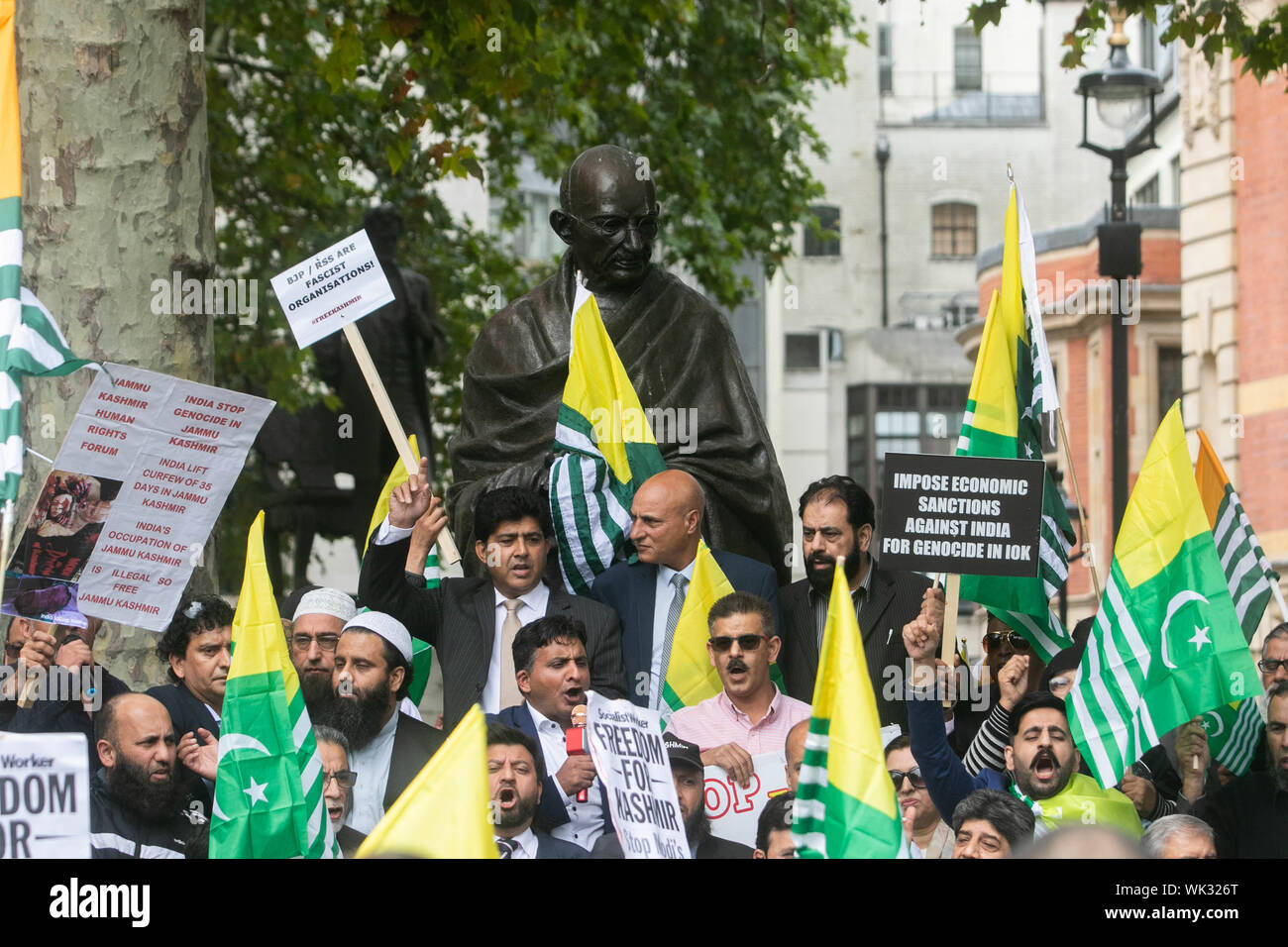 London, UK. 03rd Sep, 2019. Protesters wave Kashmiri flags as they gather in Parliament Square around the statue of Gandhi in solidarity with the people of Kashmir after Indian Prime Minister Narendra Modi delivered an Independence Day speech to remove the special rights of Kashmir as an autonomous region. Credit: SOPA Images Limited/Alamy Live News Stock Photo