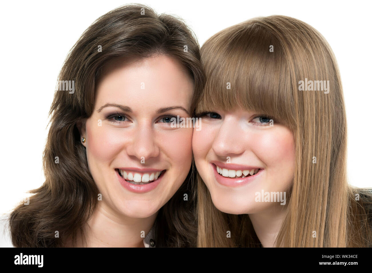 Portrait of two happy women, blond and brunette, isolated on white ...