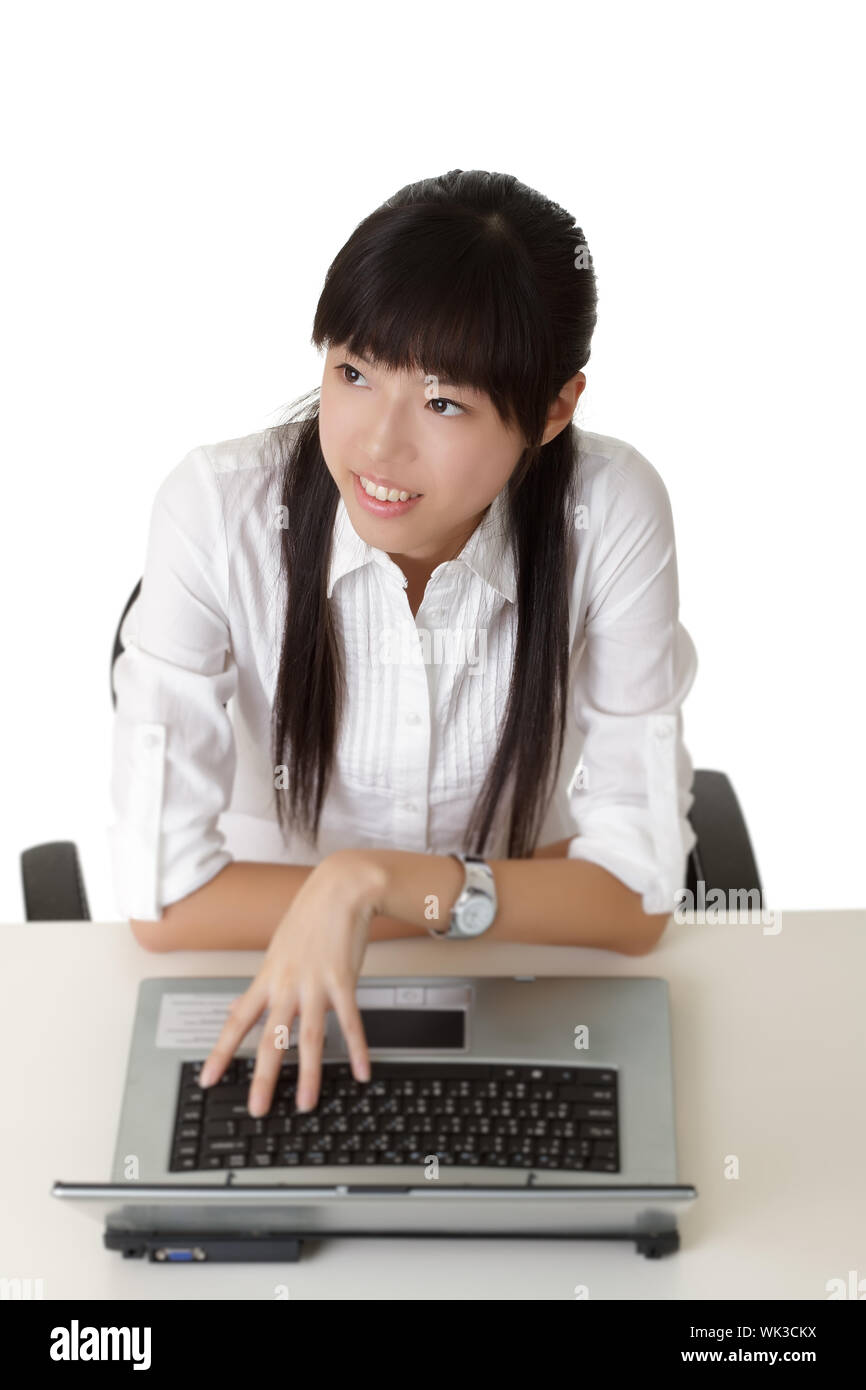 Young business woman working in office with laptop on desk. Stock Photo