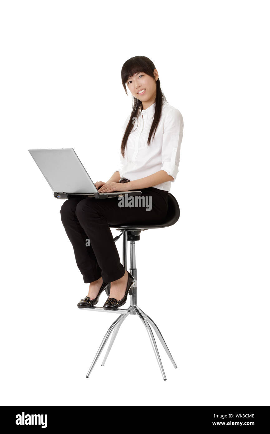 Portrait of beautiful young business woman working and siting on chair isolated over white background. Stock Photo