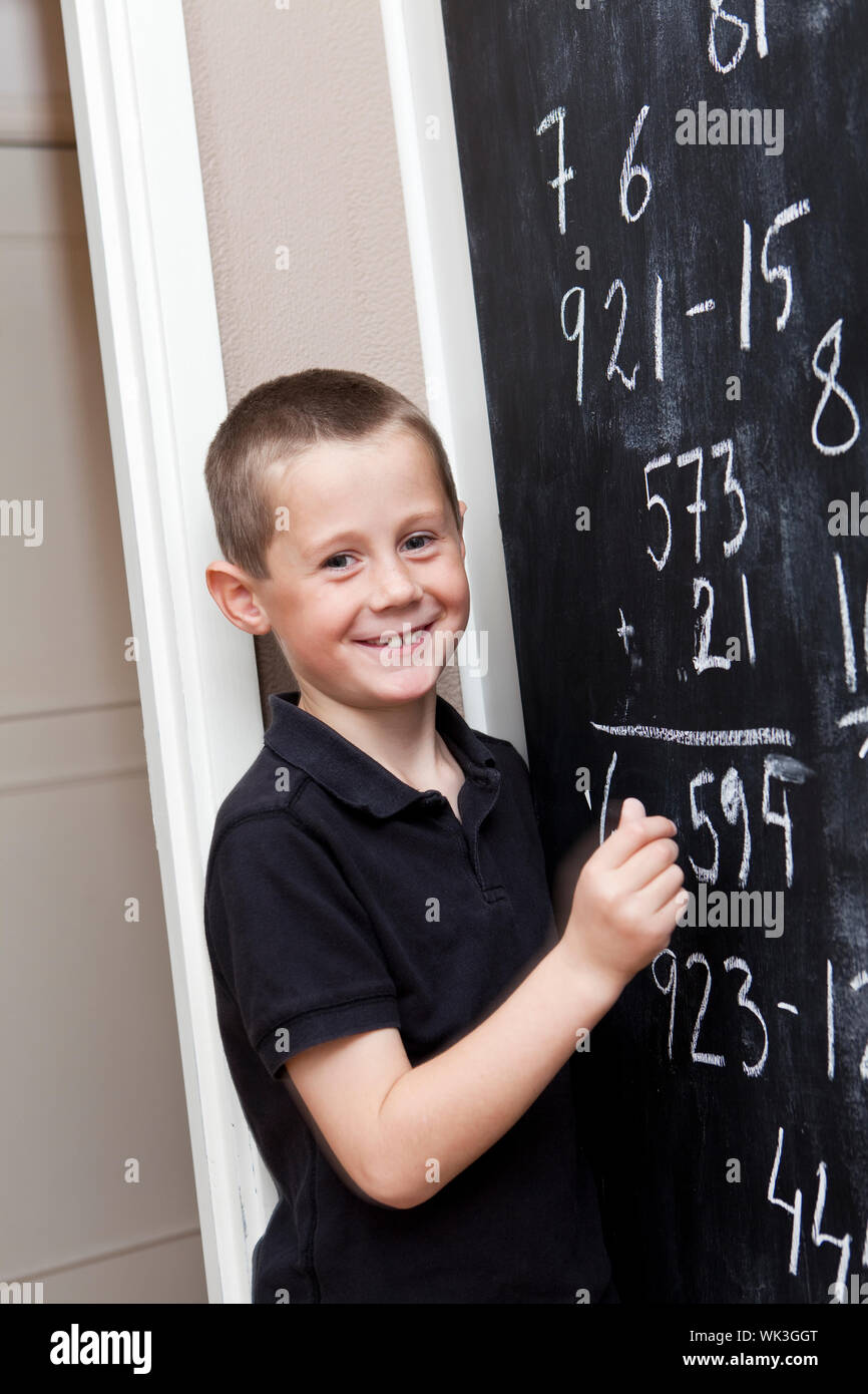 Young Boy in front of the blackboard at school Stock Photo - Alamy