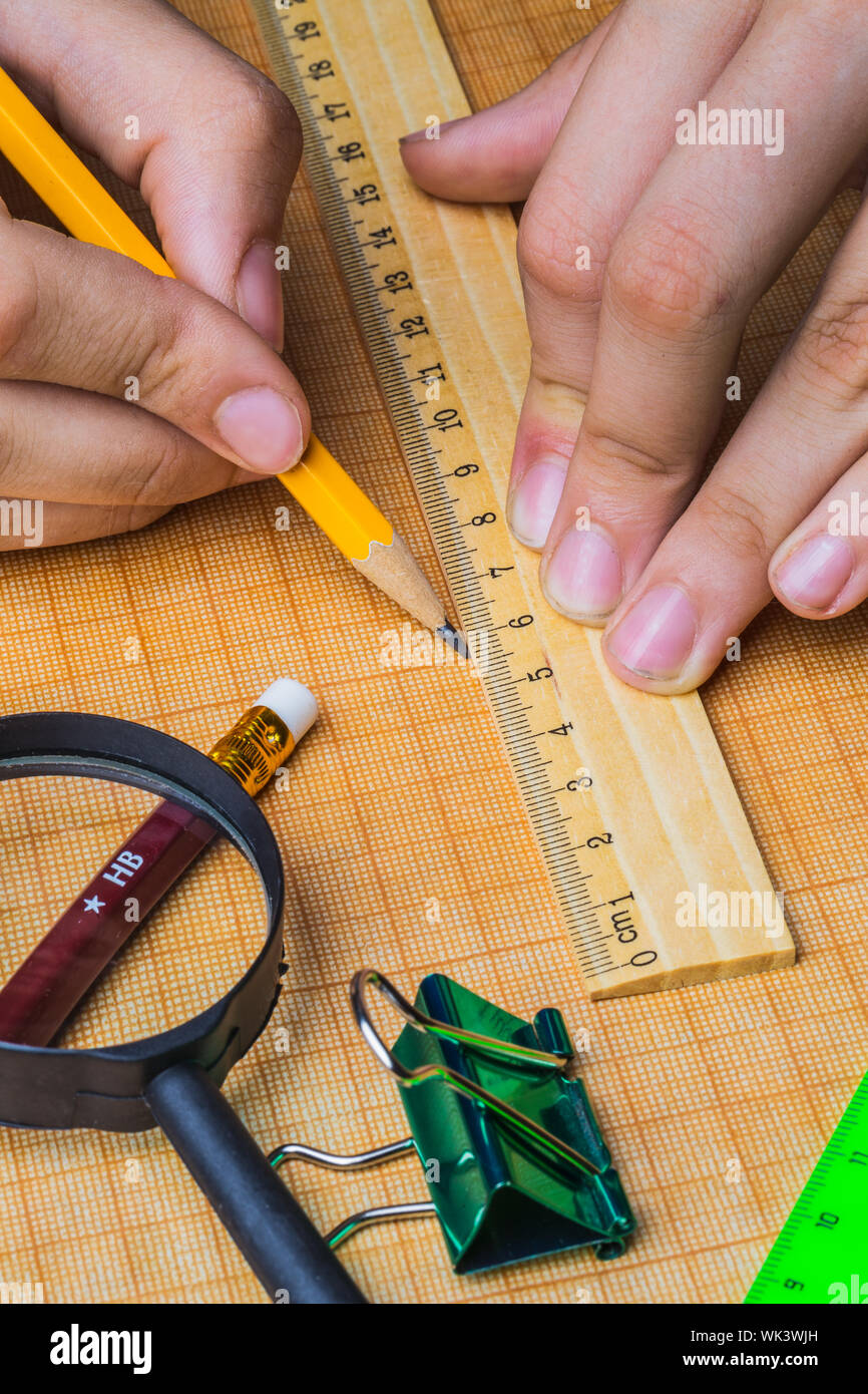 draftsman draws on a ruler on the graph paper Stock Photo - Alamy