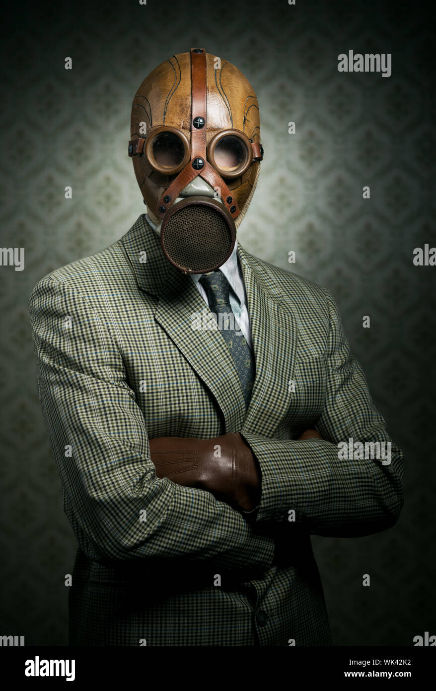 Vintage businessman wearing a gas mask with retro wallpaper on
