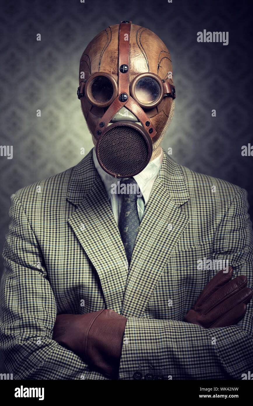 Vintage businessman wearing a gas mask with retro wallpaper on background Stock Photo - Alamy Vintage businessman wearing a gas mask with retro wallpaper on background Stock Photo - Alamy
