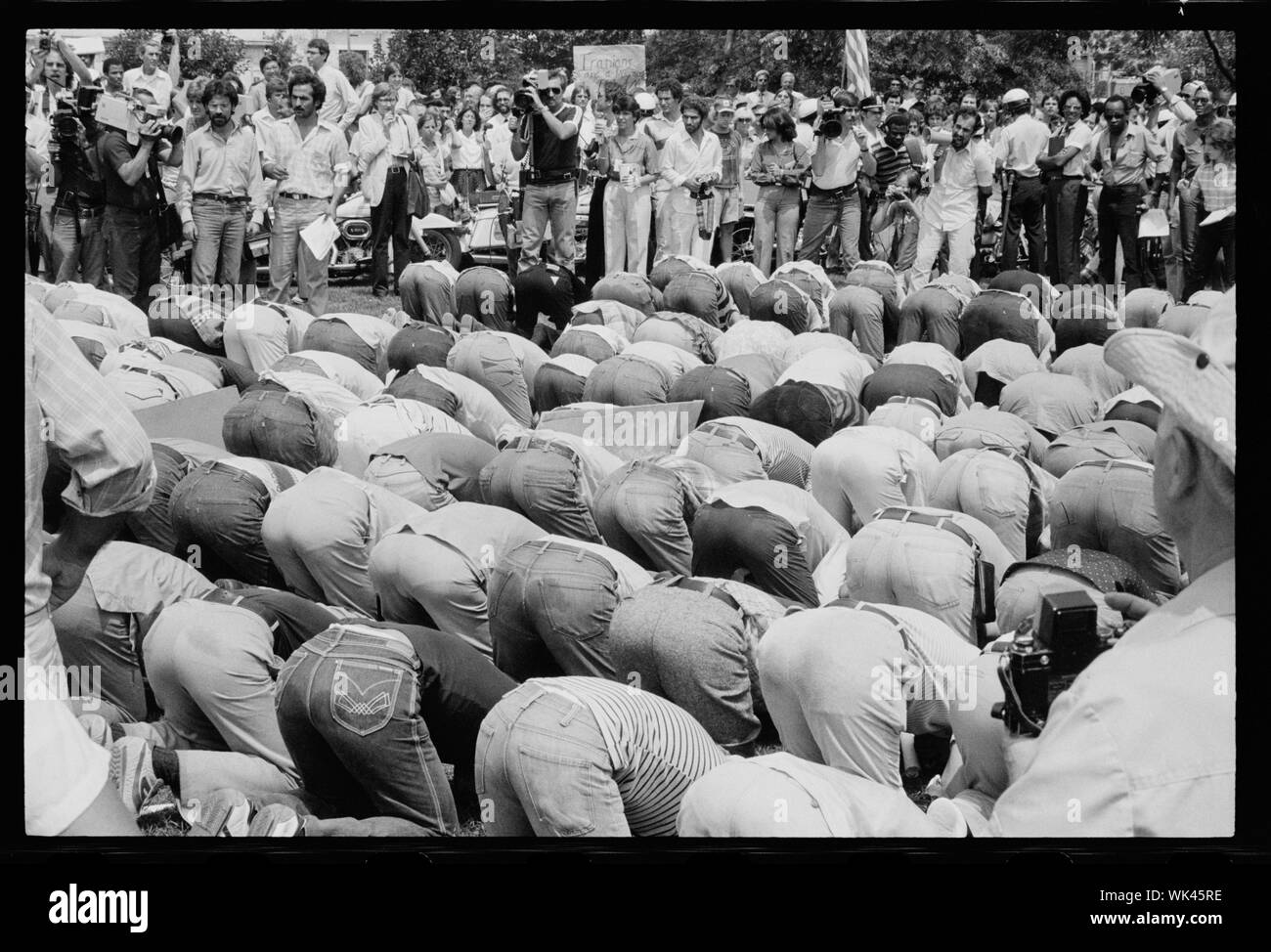 Iranian men bow in prayer during demonstration for Khomeini in Washington, D.C.;  Iranian men bow in prayer during demonstration for Khomeini in Washington, D.C. Stock Photo