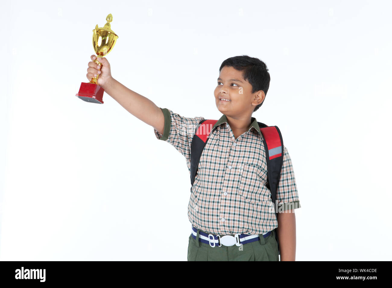 Indian schoolboy showing a trophy and smiling Stock Photo