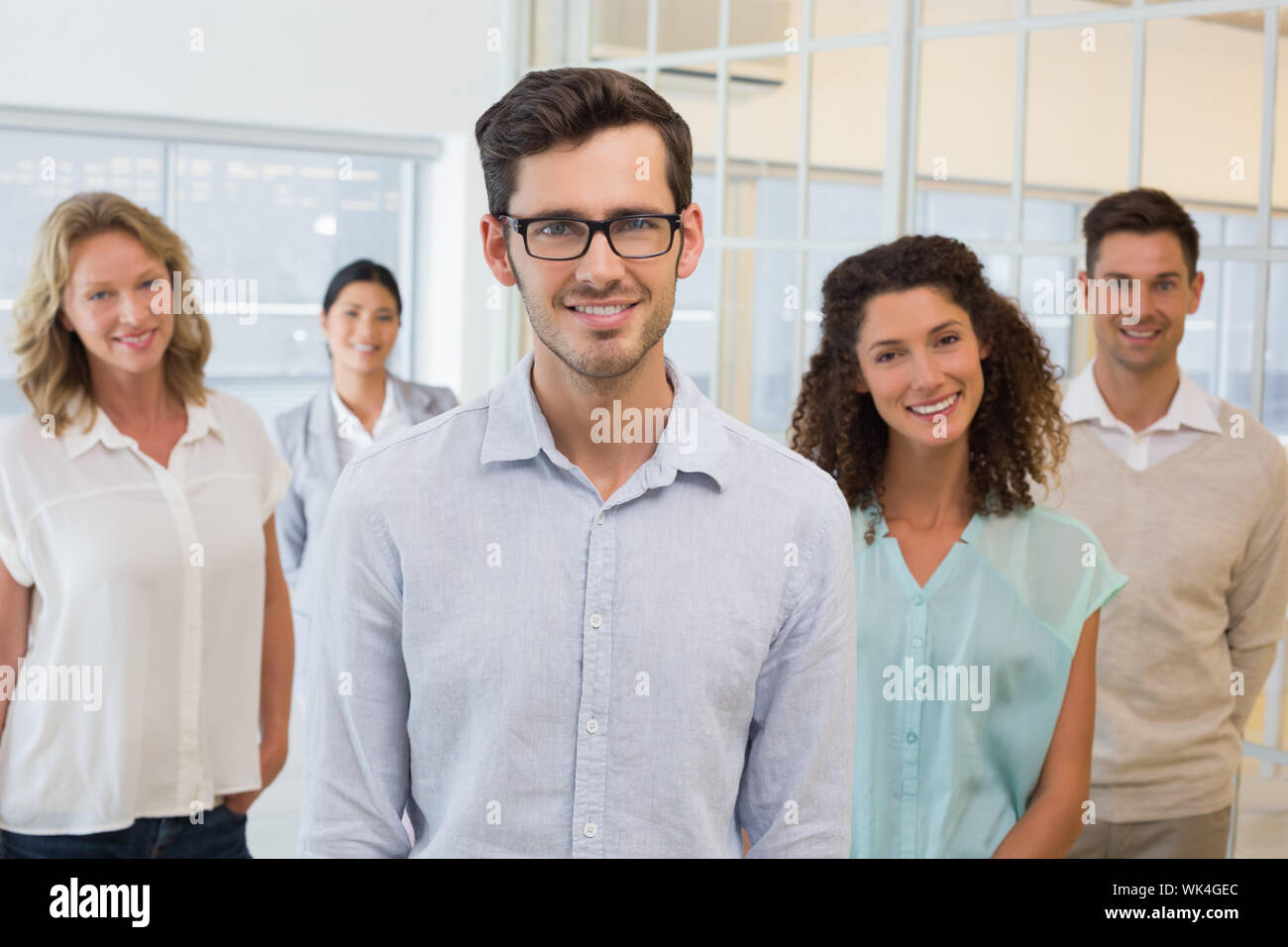 Casual business team smiling at camera in the office Stock Photo - Alamy