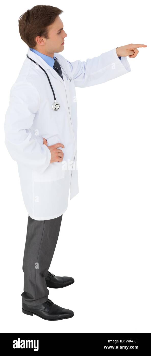 Young doctor in lab coat pointing on white background Stock Photo Alamy