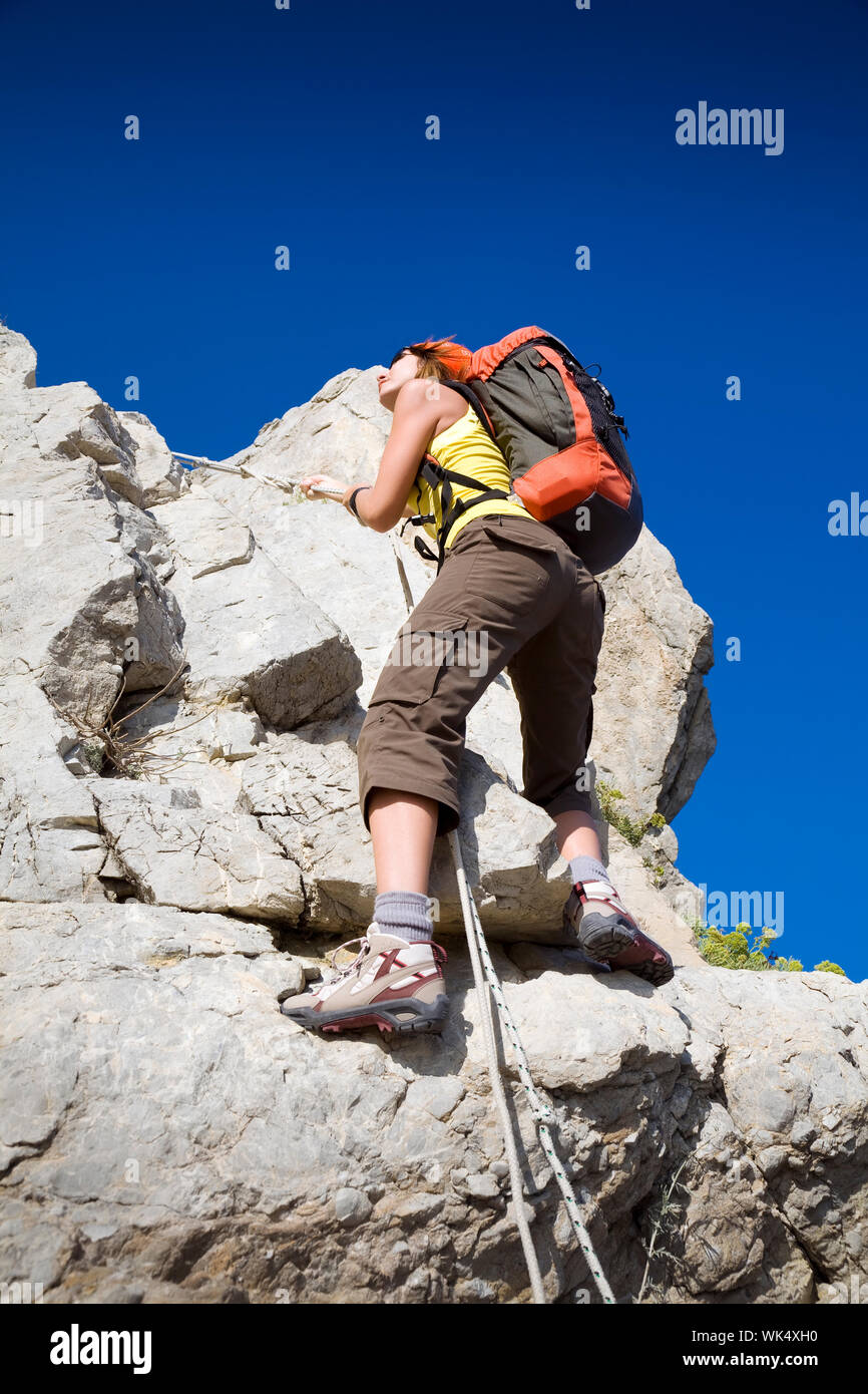 young woman reaching the top of a mountain. Copy space Stock Photo