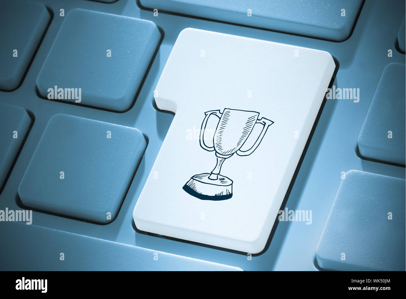 Winners cup against white enter key on keyboard Stock Photo