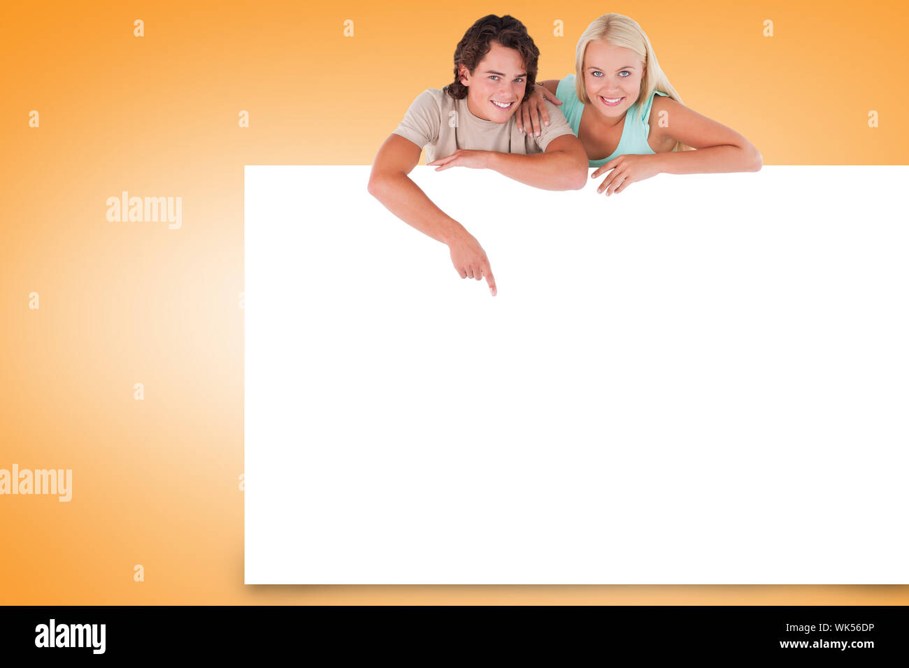 Composite image of attractive couple showing white card Stock Photo - Alamy
