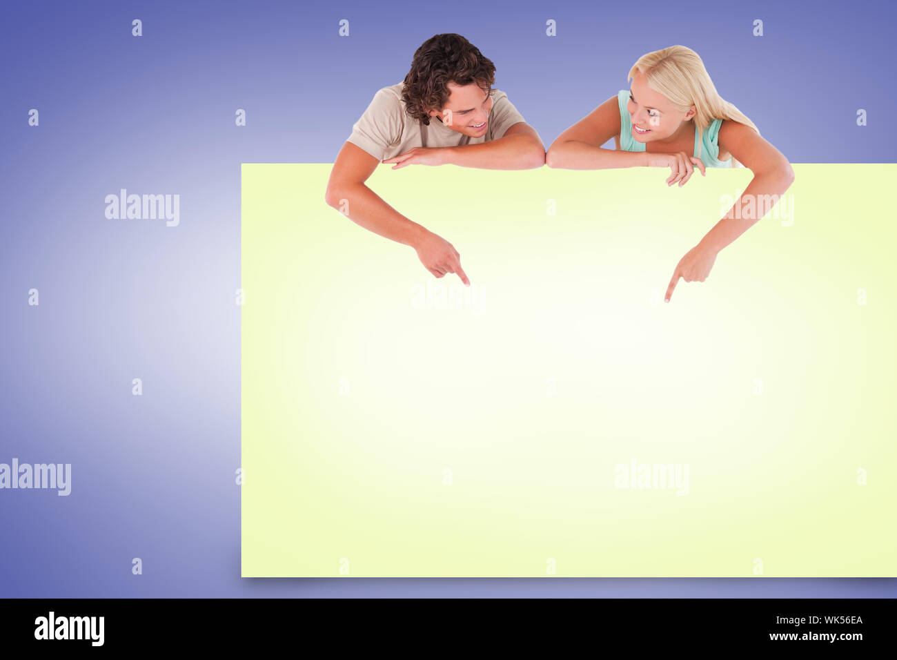 Composite image of attractive couple showing yellow card Stock Photo ...