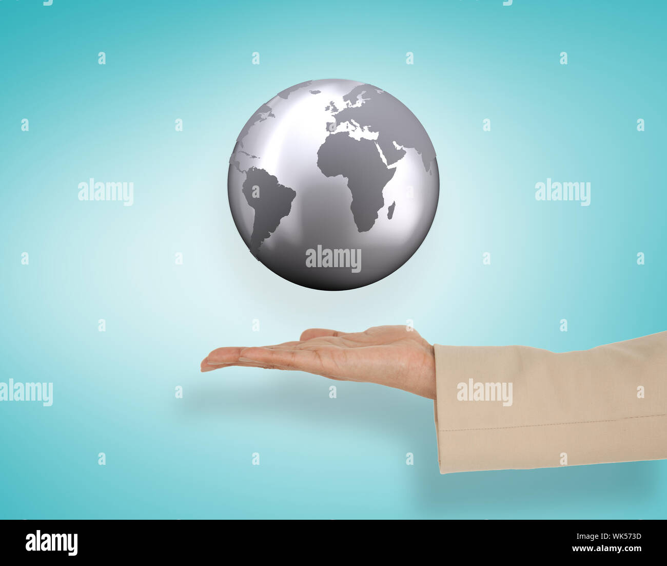 Female hand presenting globe against blue vignette Stock Photo