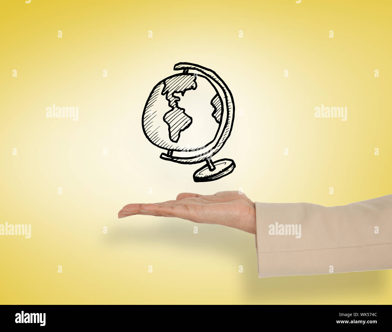 Female hand presenting globe against yellow vignette Stock Photo