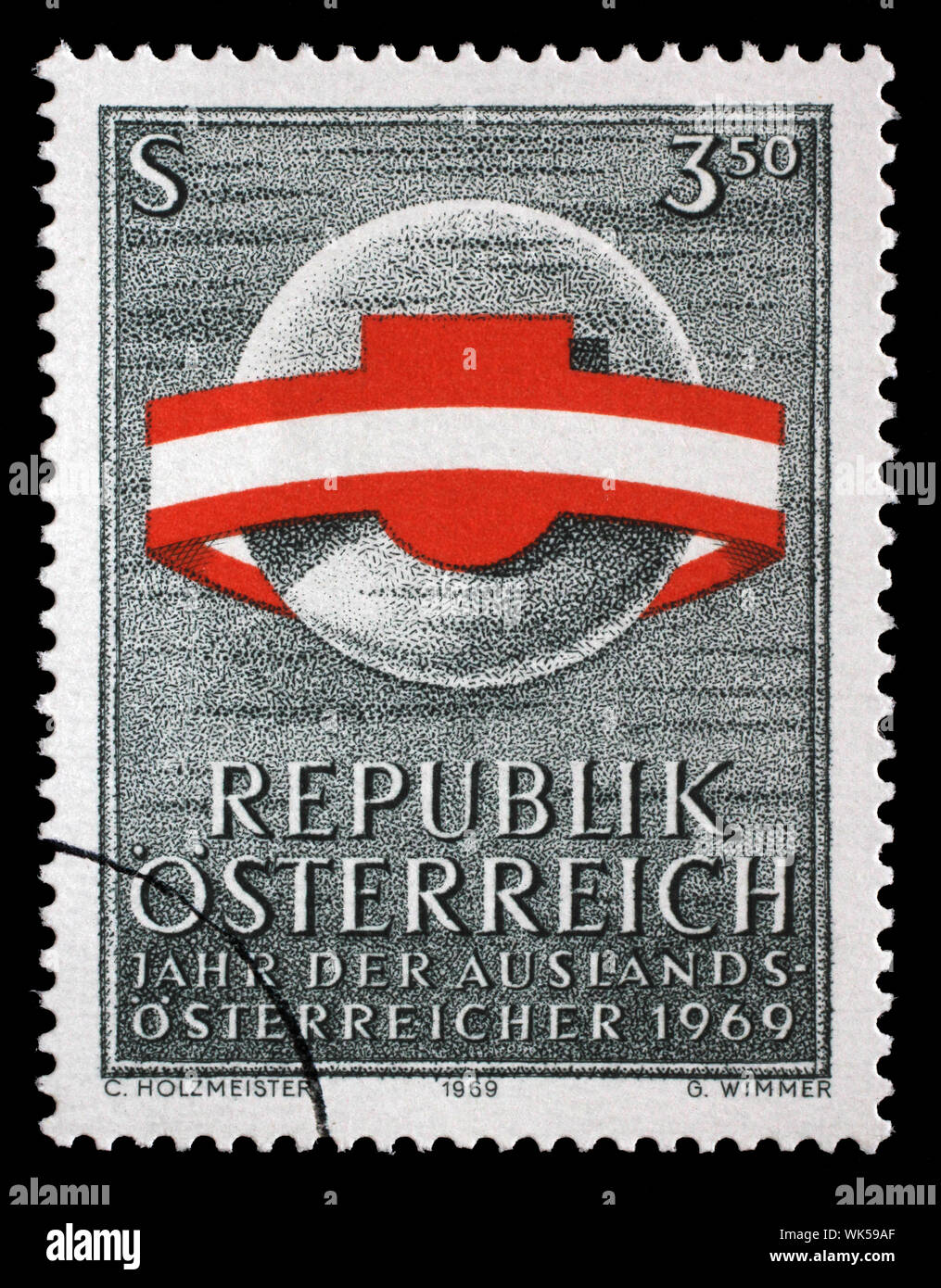Stamp issued in the Austria shows the Globe surrounded by Austrian flag ribbon, Year of Expatriate Austrians, circa 1969. Stock Photo