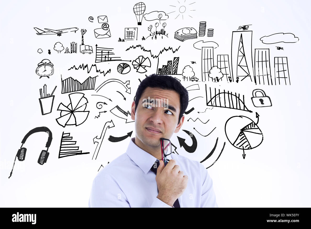 Thinking businessman holding glasses against brainstorm graphic Stock Photo