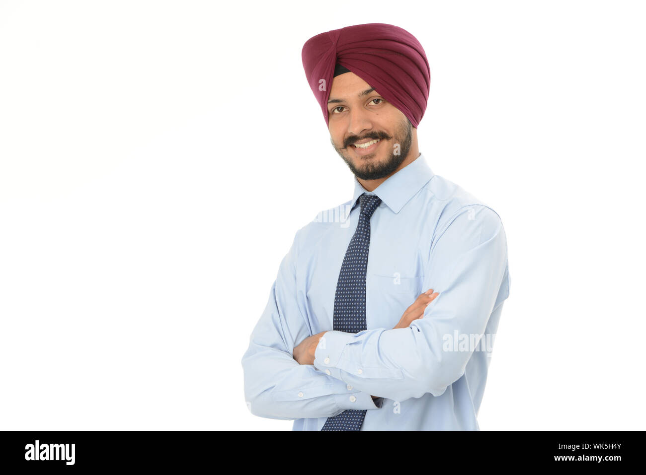 Indian businessman standing with his arms crossed Stock Photo - Alamy