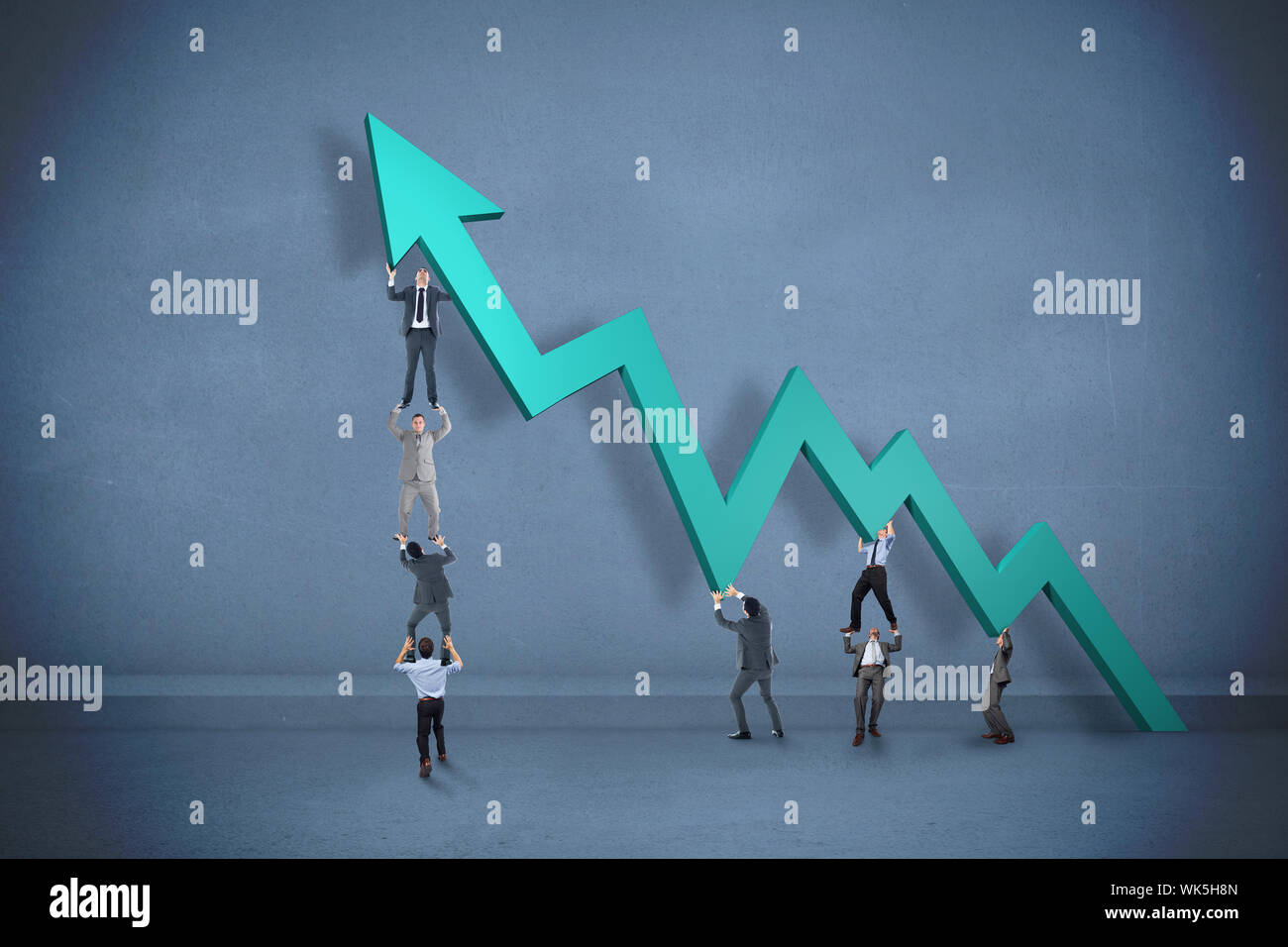Business team holding up arrow against dark room Stock Photo - Alamy
