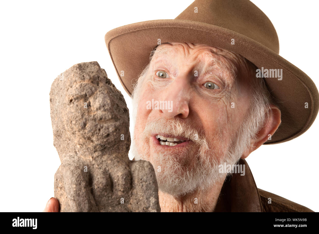 Adventurer or archaeologist in brown leather jacket defending himself with  abcient weapon Stock Photo - Alamy