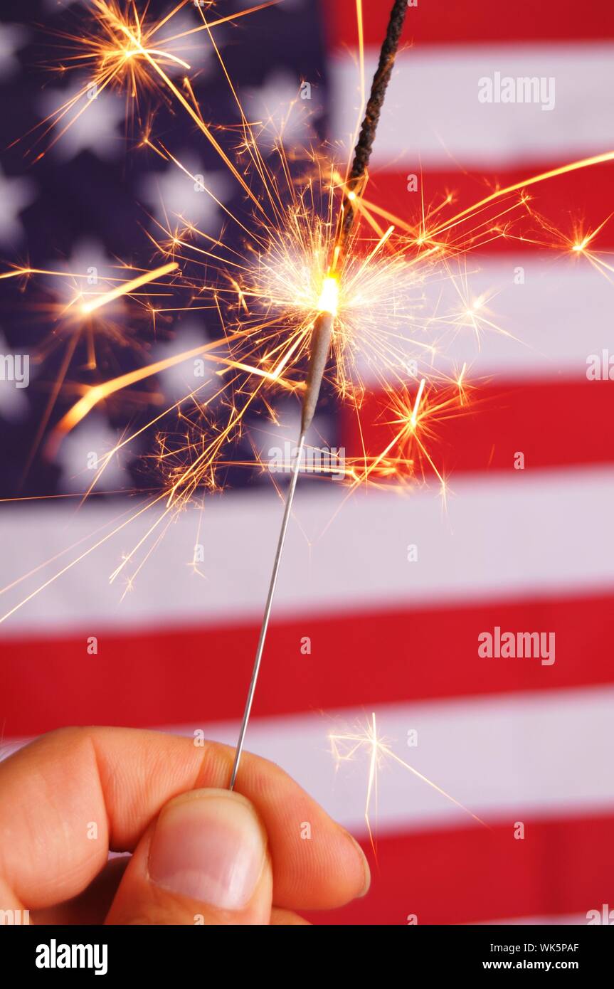 sparkler and usa flag showing 4th of july Stock Photo - Alamy
