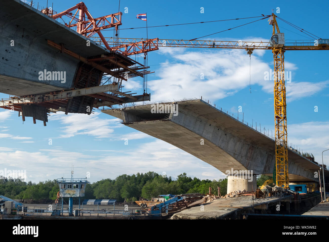 Low Angle View Of Cranes Over Bridge At Construction Site On Sunny Day Stock Photo