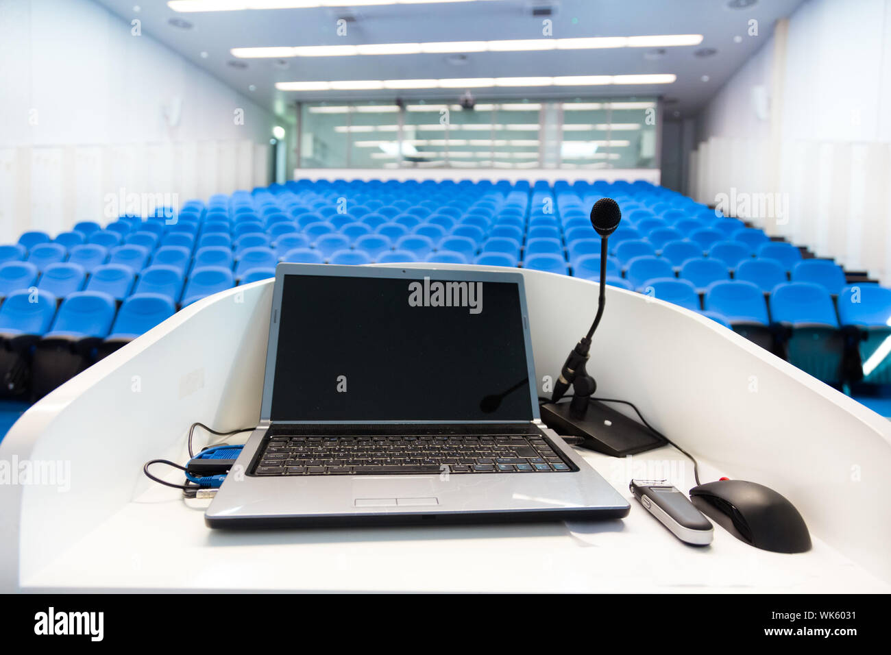 Laptop on the rostrum in conference hall. Stock Photo