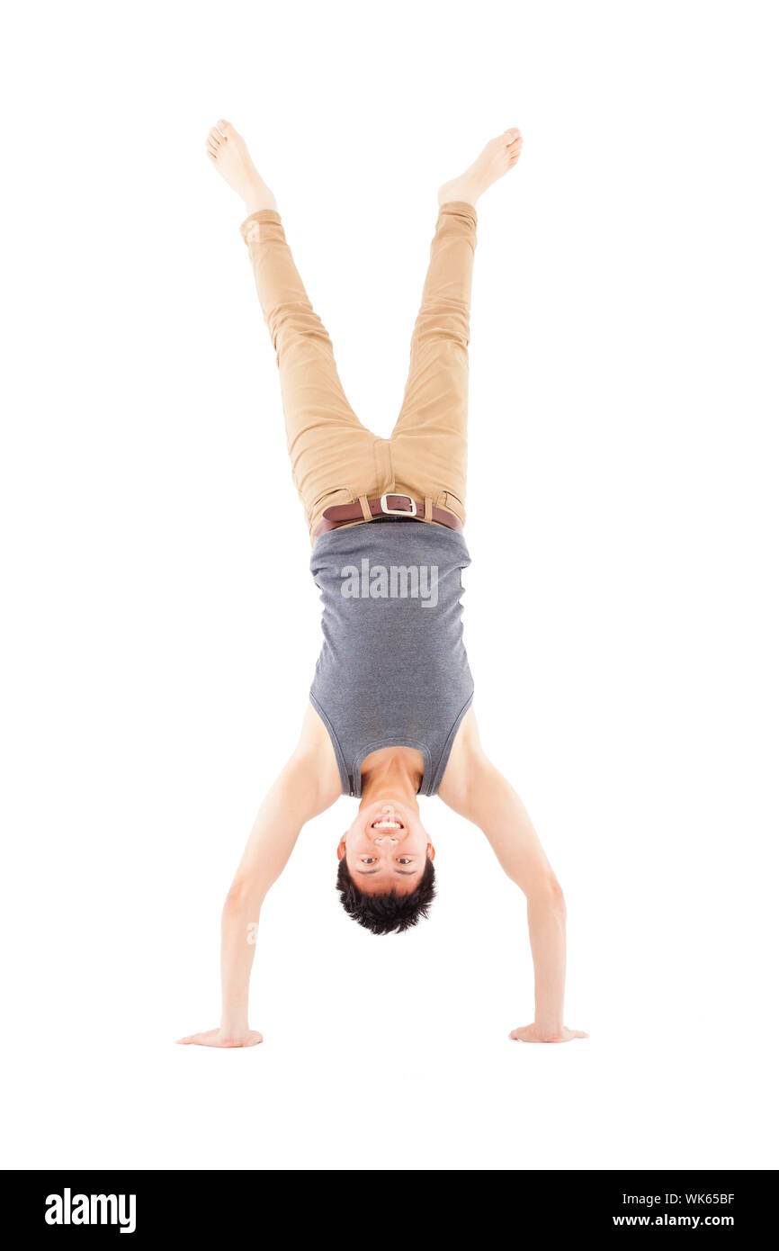 young man doing a handstand against on white background Stock Photo