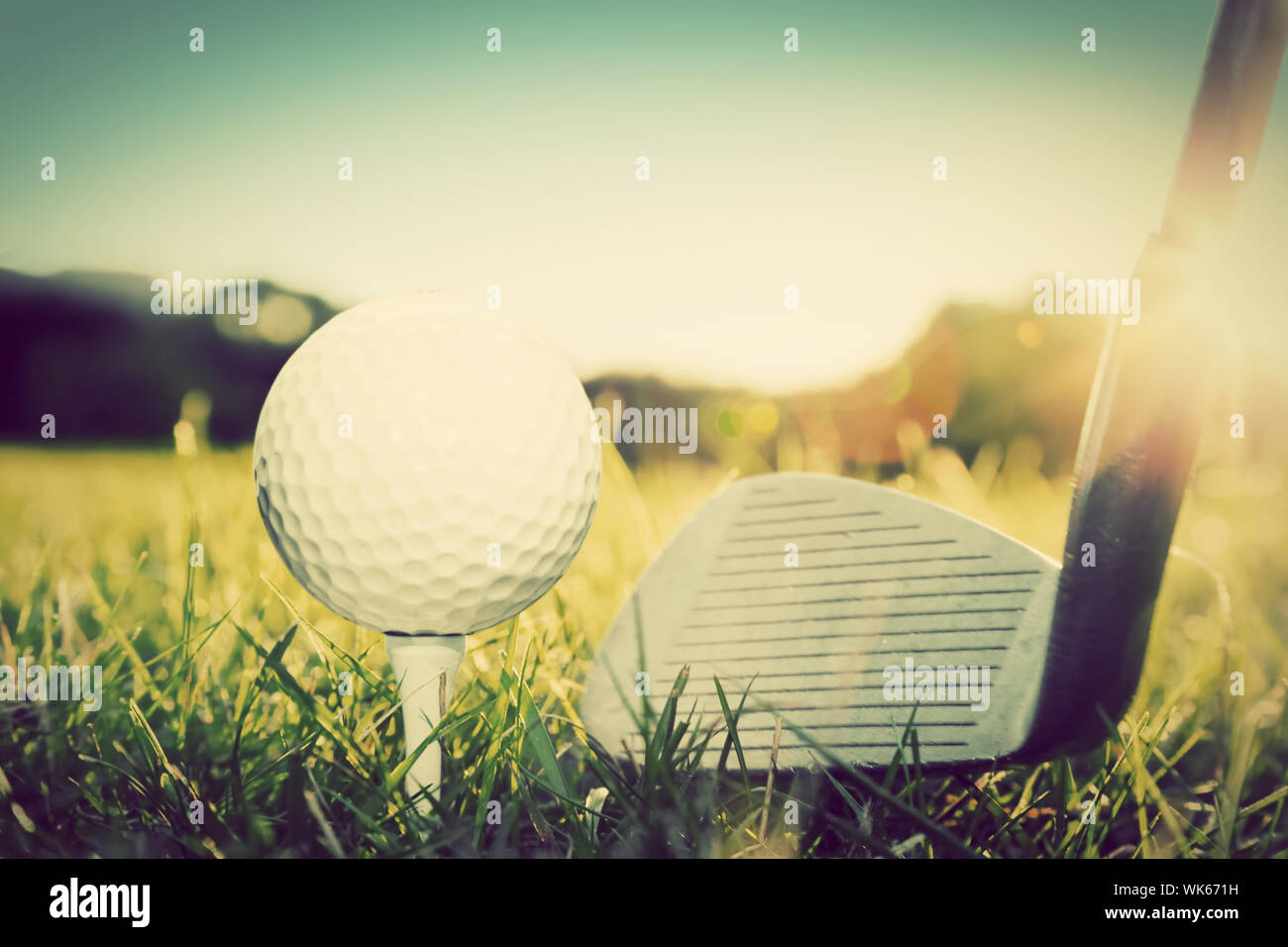 Playing golf, ball on tee and golf club about to shot. Vintage, retro