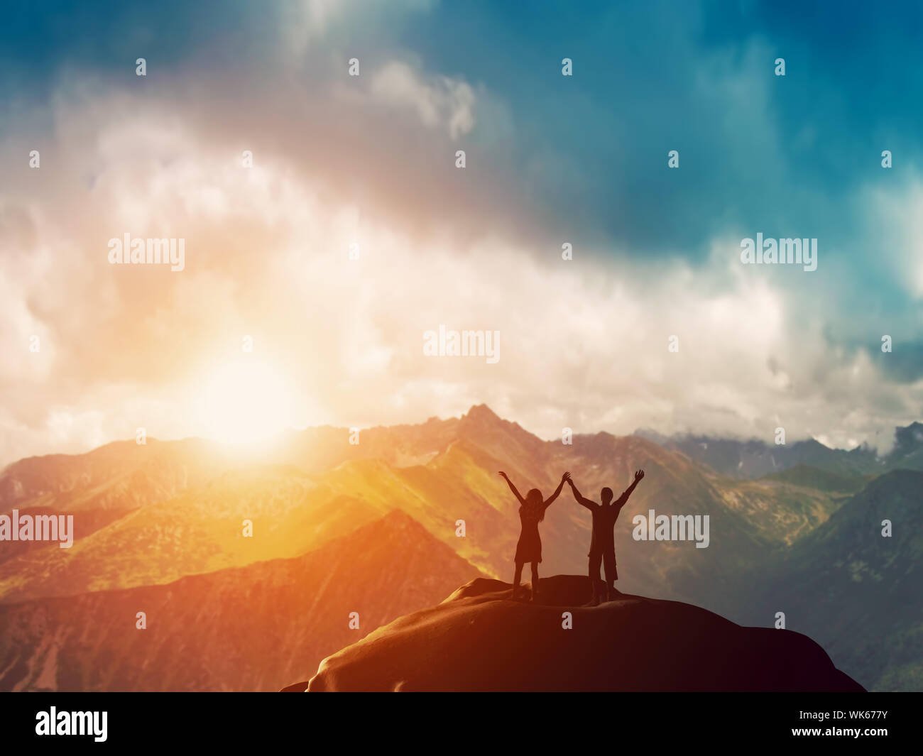 Young couple standing on a mountain top hi-res stock photography and ...