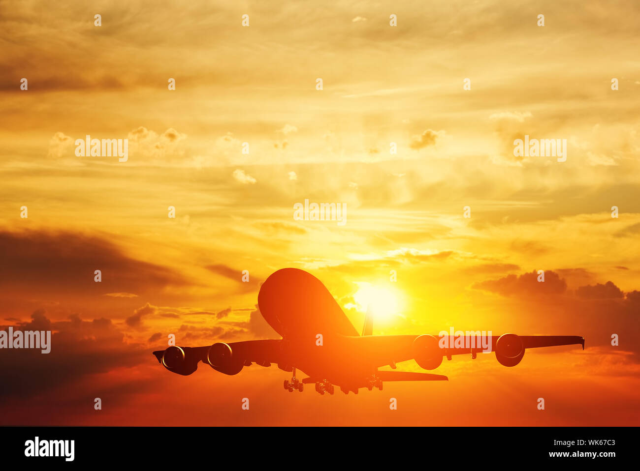 Airplane taking off at sunset. Silhouette of a big passenger or cargo ...