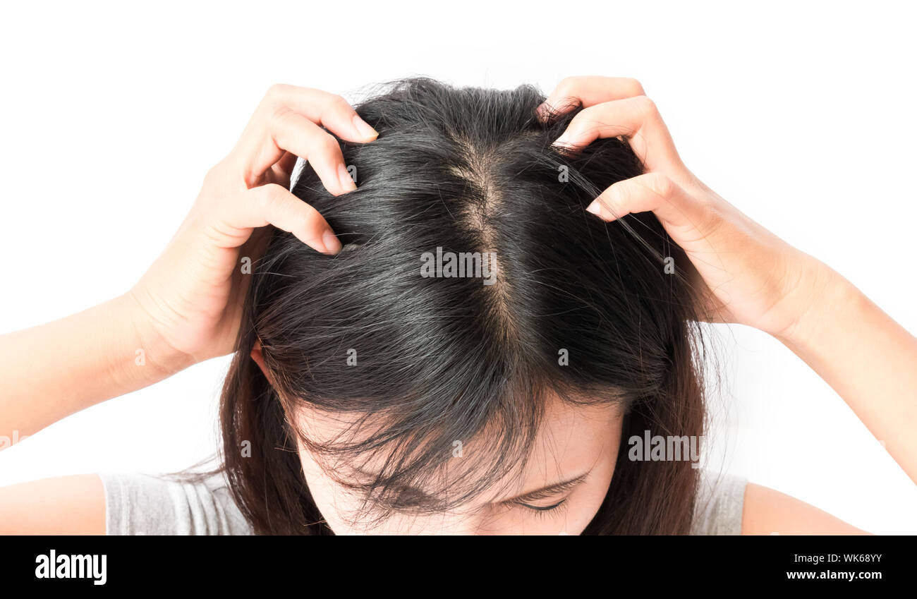 Close-up Of Woman Hand Massaging Scalp Against White Background Stock Photo