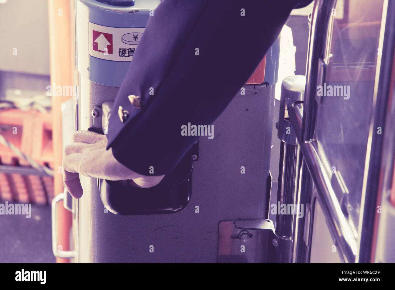 Bus driver pick a bus ticket in the ticket machines Stock Photo - Alamy