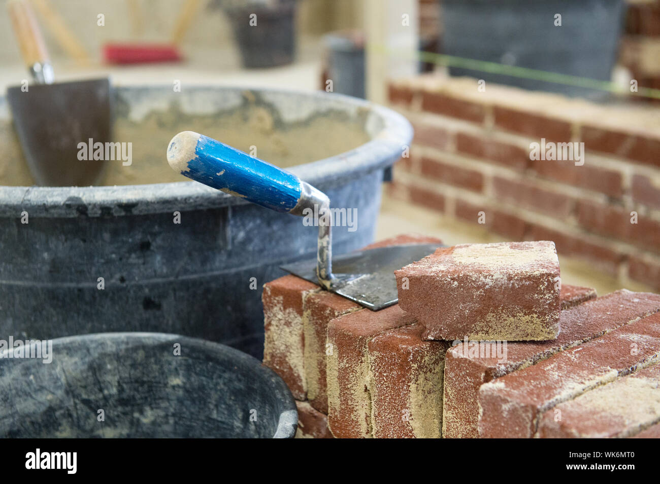 trowel and mortar to build a wall with bricks Stock Photo Alamy