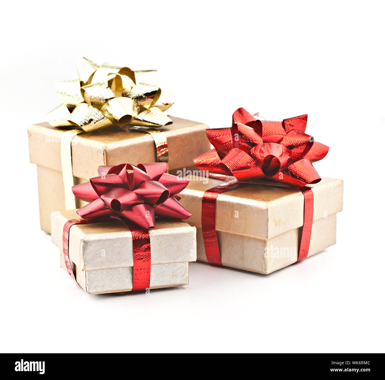 On a white background golden gift box with red ribbon and gold braid ...