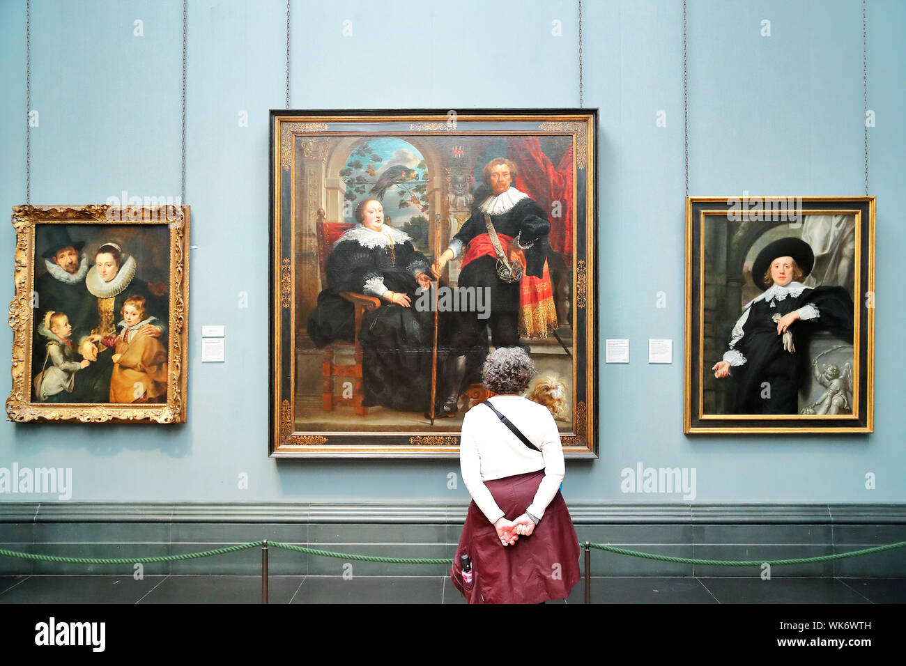 Woman standing in front of a work of Flemish Baroque painter Jacob Jordaens at the National Gallery, Trafalgar Square, London, UK Stock Photo