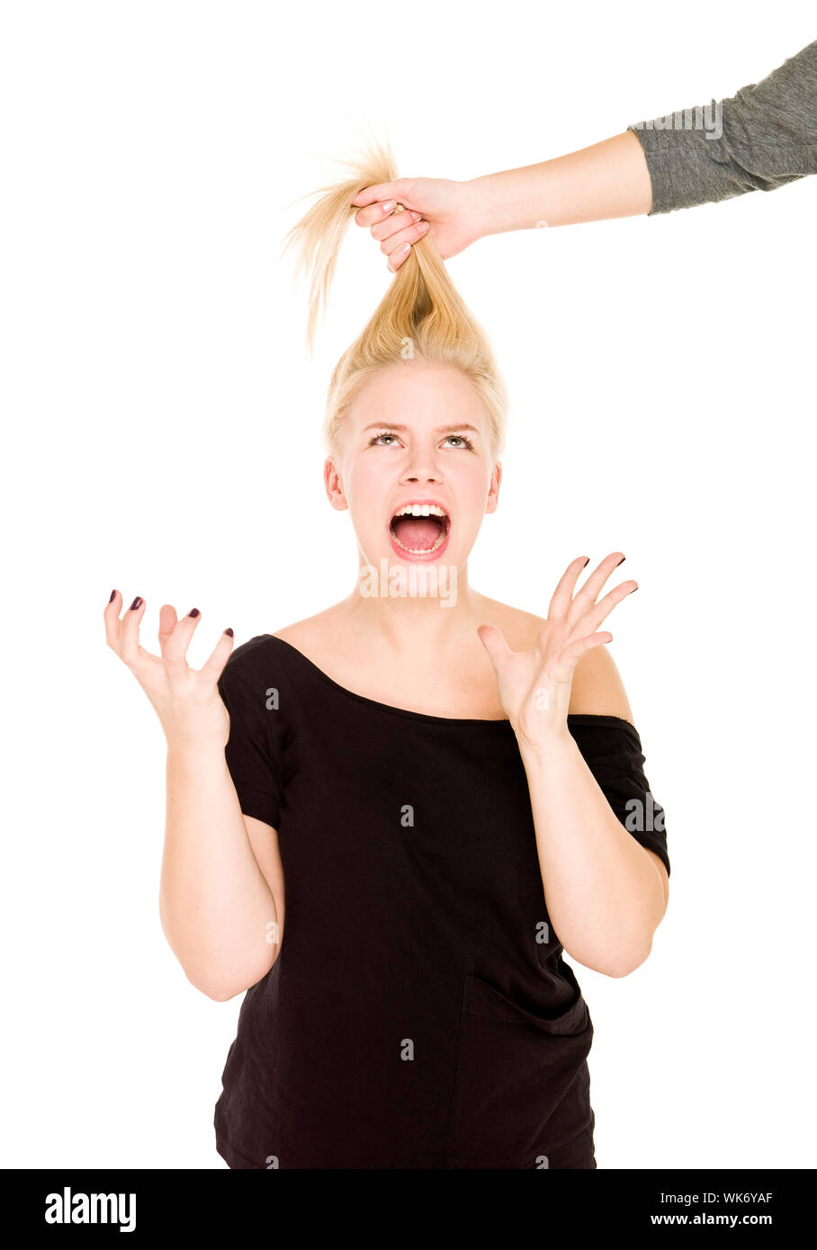 Blond woman in pain because someone pulling her hair Stock Photo